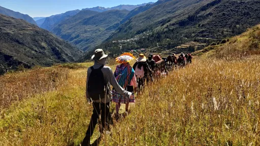 People walking across a mountain landscape