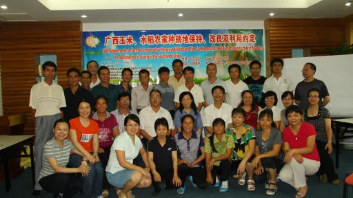 People pose in front of ABS agreement poster