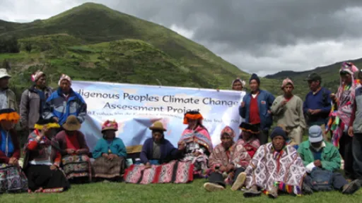 People in front of a banner: Indigenous Peoples Biocultural Assessments Initiative
