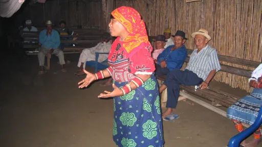 Kuna woman stands talking in a community workshop 