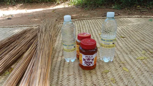 A close-up photo of bottles of natural honey and coconut oil.